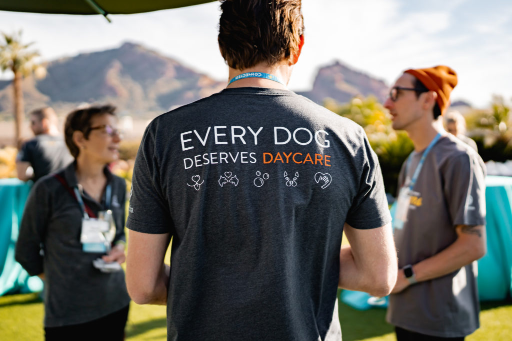 Person with shirt that says every dog deserves daycare