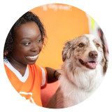 Woman smiling at dog at Dogtopia
